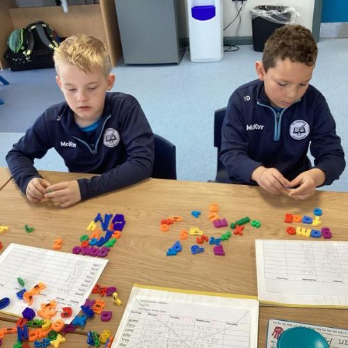 Using magnetic letters to build words with our sound of the week in them.